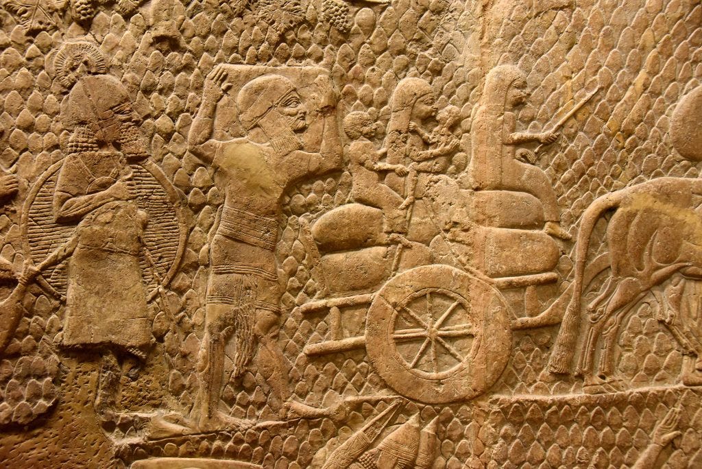 An Assyrian soldier watches a deported family form Lachish. A man holds a large box on his shoulders. A young woman guides a 2-wheeled cart pulled by a bullock while another women holds a boy and a girl. The family tried to bring with them as much as they could of their household belonginngs. From Nineveh (modern-day Mosul Governorate, Iraq), Room XXXVI of the South-West Palace, panels 8-9. The British Museum, London. Photo © Osama S. M. Amin.