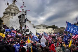 Image of the capitol building being stormed by Jan 6 coup goons and trump and US flags